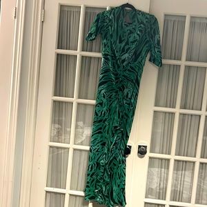 Green leopard print dress with opened back and frills.